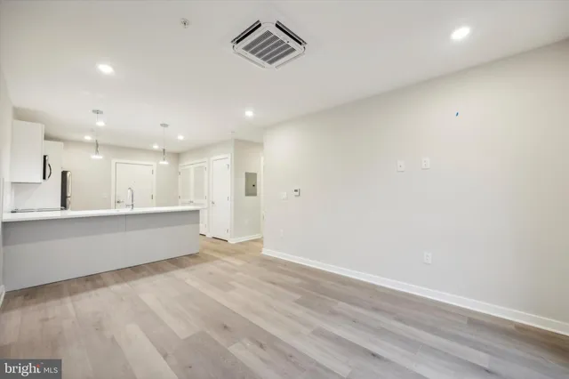 a view of kitchen with wooden floor and electronic appliances