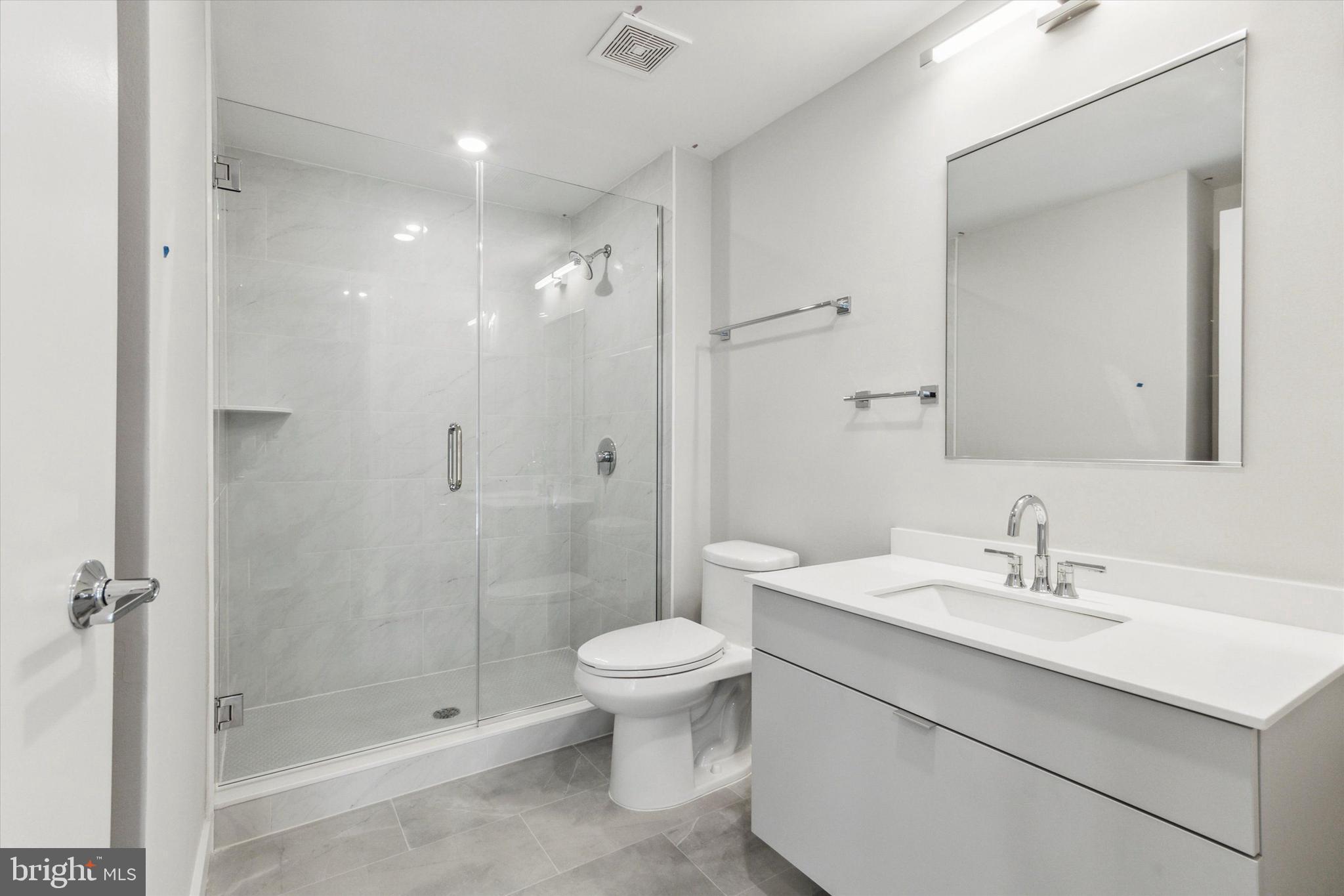 3449 Scotts Lane, Unit A202 Philadelphia, PA 19129 - Photo 14 of 14 a bathroom with a sink a toilet and shower