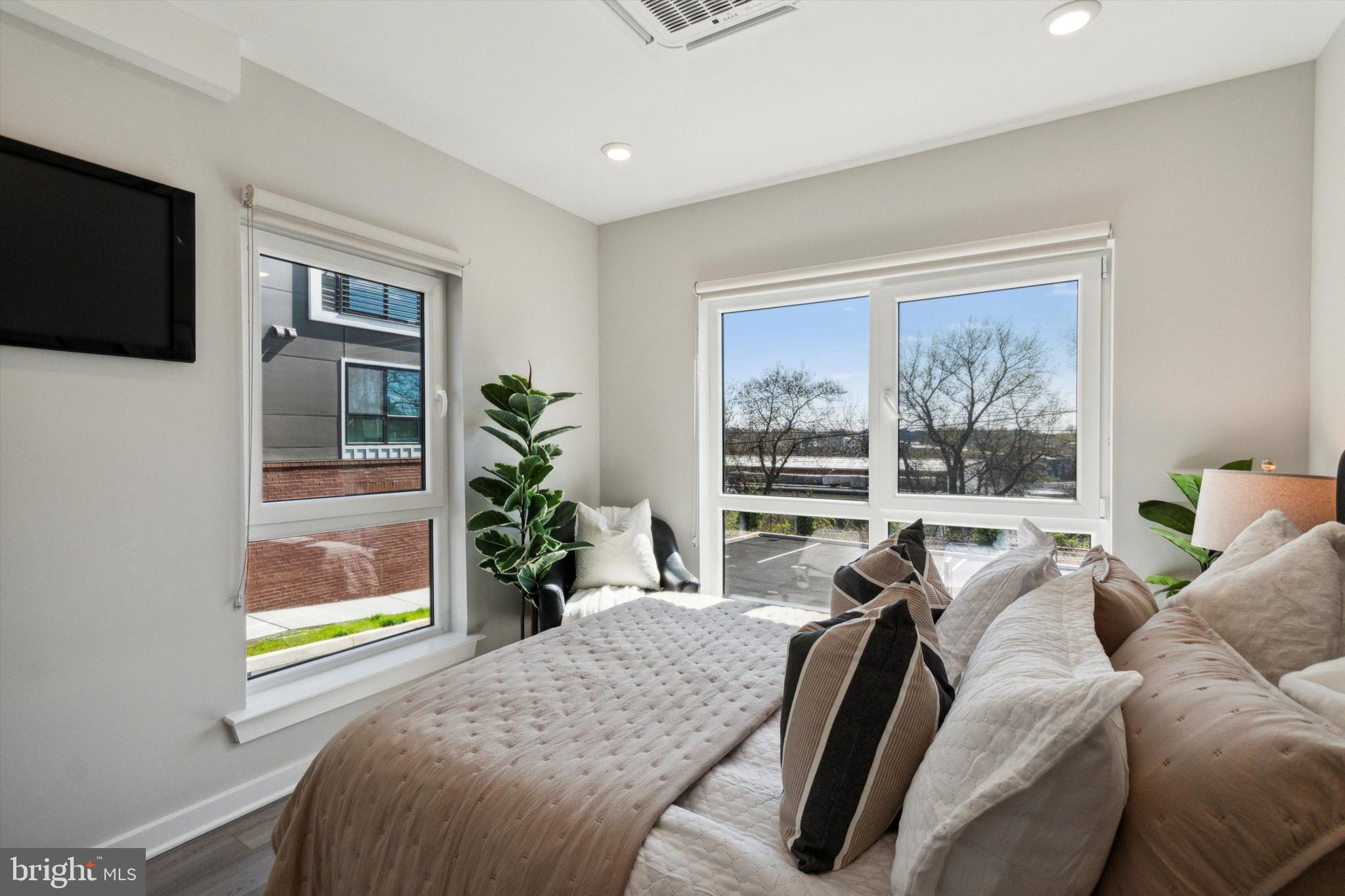 3449 Scotts Lane, Unit A202 Philadelphia, PA 19129 - Photo 10 of 14 a living room with furniture tv and a window