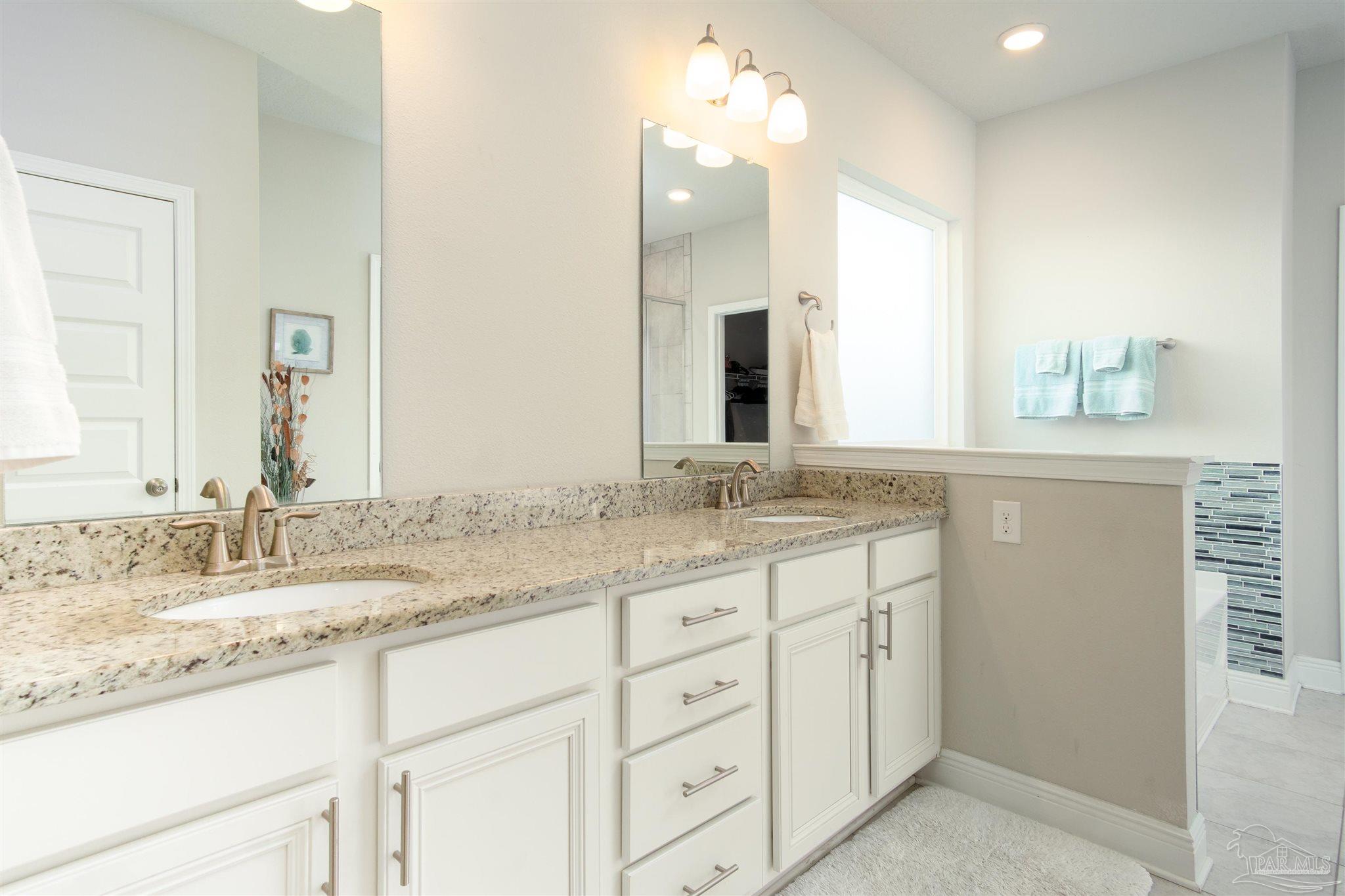 2759 Gemstone Circle Pace, FL 32571 - Photo 11 of 36 a bathroom with a granite countertop sink double and mirror