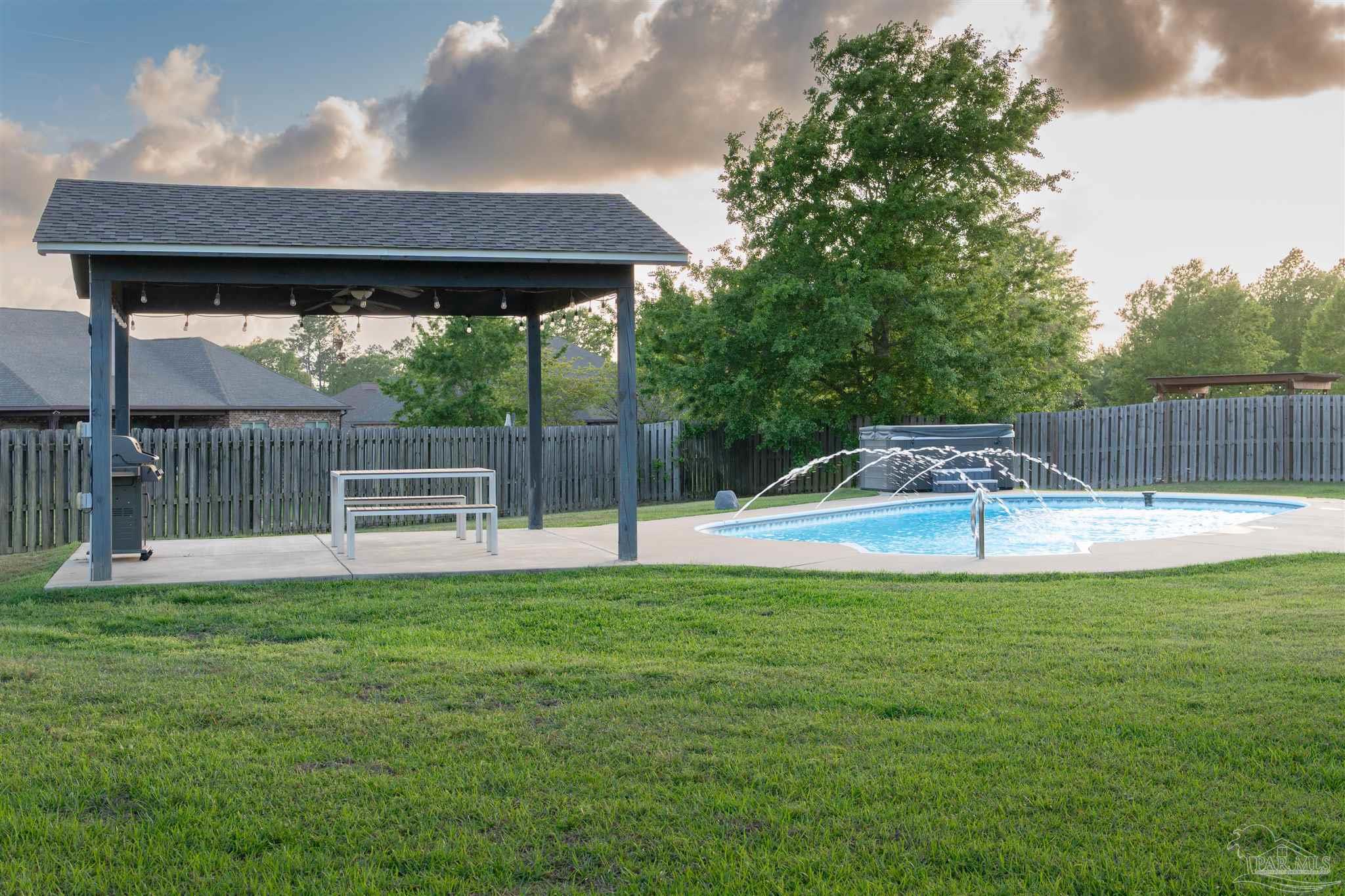2759 Gemstone Circle Pace, FL 32571 - Photo 15 of 36 a swimming pool with outdoor seating and yard