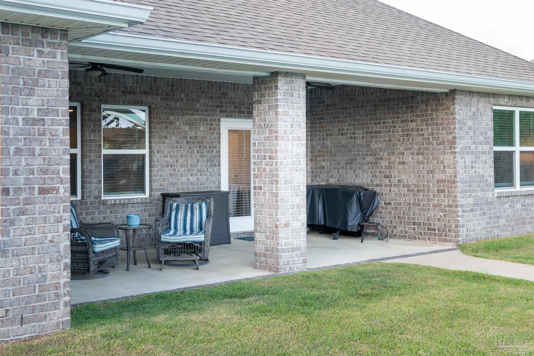 2759 Gemstone Circle Pace, FL 32571 - Photo 16 of 36 a view of front door of house with outdoor seating