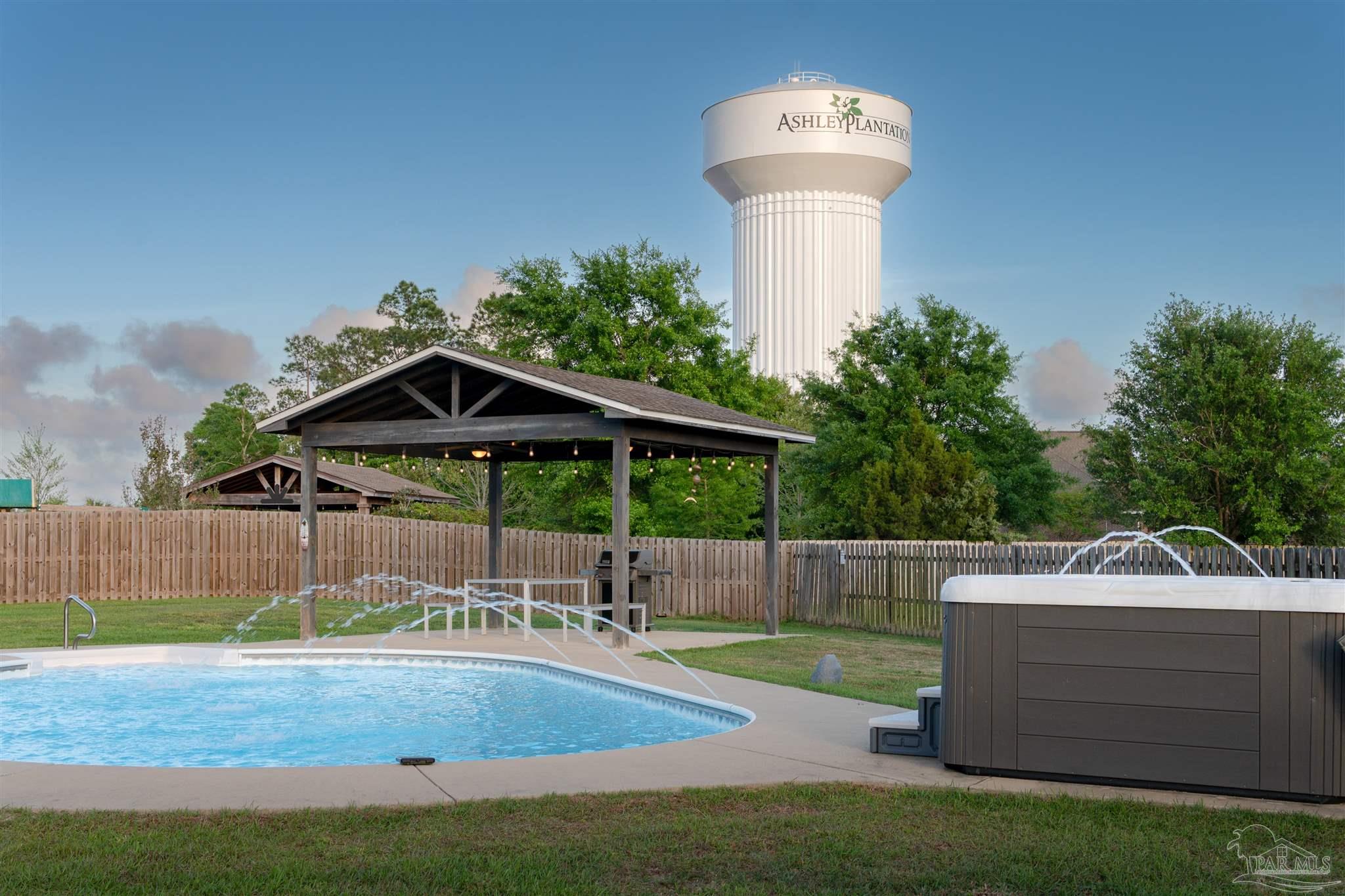 2759 Gemstone Circle Pace, FL 32571 - Photo 2 of 36 a view of a small yard and a fountain