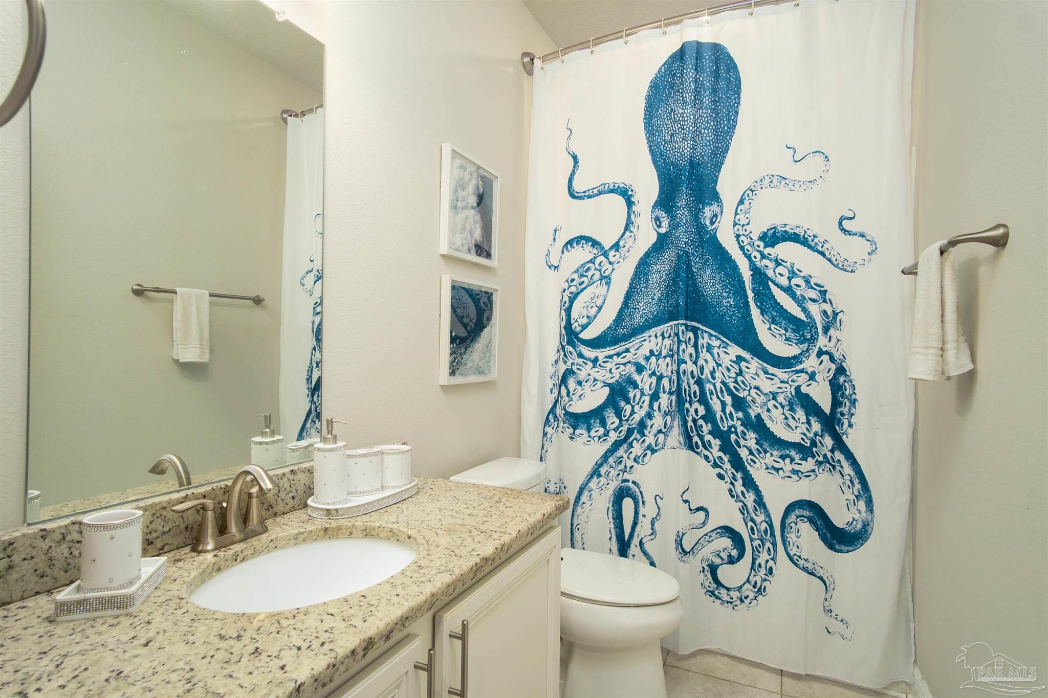 2759 Gemstone Circle Pace, FL 32571 - Photo 23 of 36 a bathroom with a granite countertop toilet and a sink