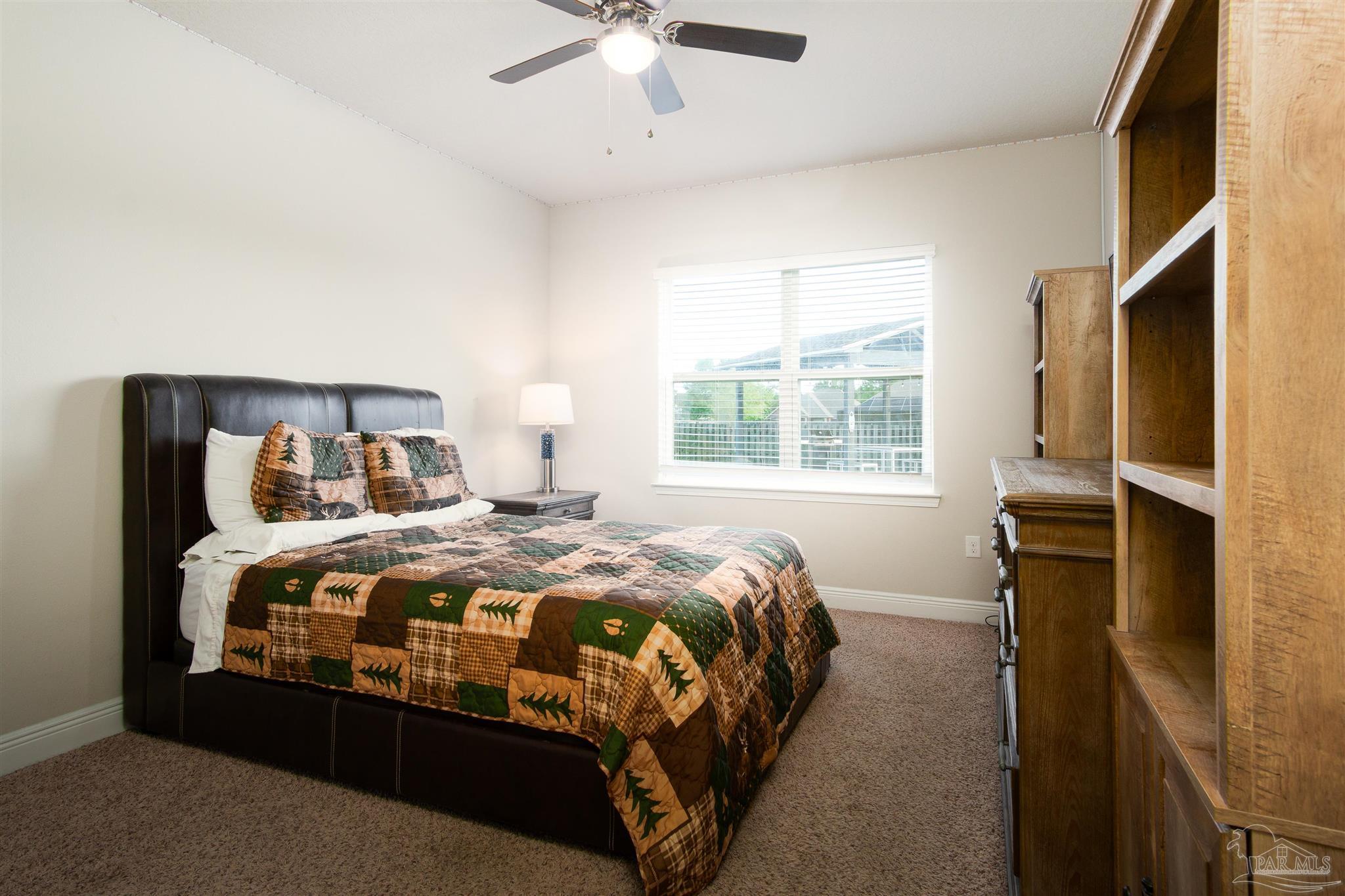 2759 Gemstone Circle Pace, FL 32571 - Photo 27 of 36 a bedroom with a bed and window