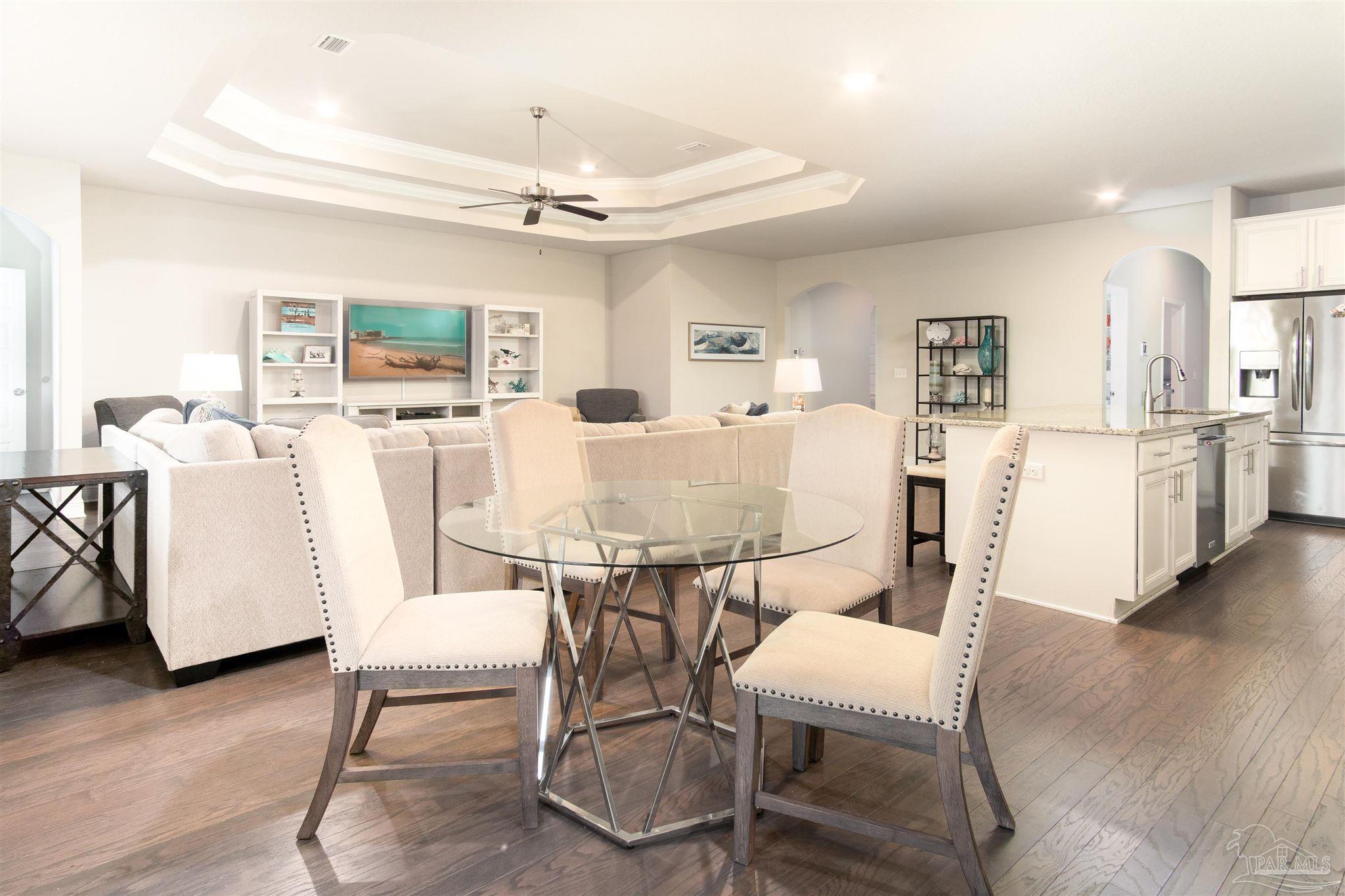 2759 Gemstone Circle Pace, FL 32571 - Photo 7 of 36 a view of a dining room with furniture and wooden floor