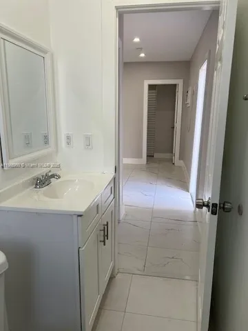 a bathroom with a sink vanity and a mirror