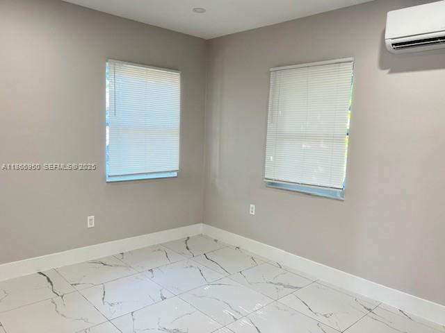 922 Northwest 2nd Street, Unit 4 Miami, FL 33128 - Photo 2 of 35 an empty room with a window