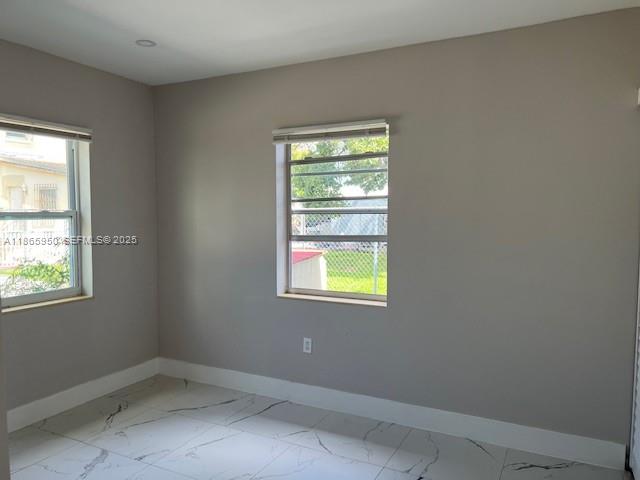 922 Northwest 2nd Street, Unit 4 Miami, FL 33128 - Photo 23 of 35 an empty room with a window and wooden floor
