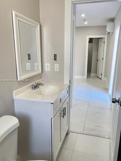 922 Northwest 2nd Street, Unit 4 Miami, FL 33128 - Photo 29 of 35 a spacious bathroom with a sink a toilet and a mirror