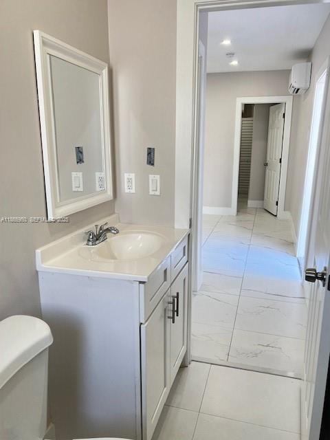 922 Northwest 2nd Street, Unit 4 Miami, FL 33128 - Photo 29 of 35 a spacious bathroom with a sink a toilet and a mirror