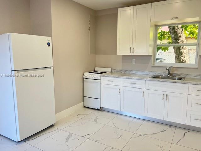 922 Northwest 2nd Street, Unit 4 Miami, FL 33128 - Photo 3 of 35 a utility room with cabinets washer and dryer