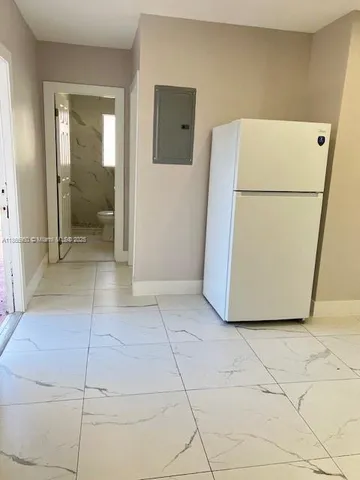 a view of a storage & utility room with a refrigerator washer and dryer