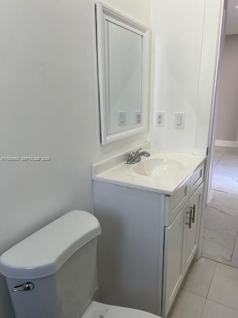 922 Northwest 2nd Street, Unit 4 Miami, FL 33128 - Photo 10 of 35 a bathroom with a sink vanity mirror and toilet