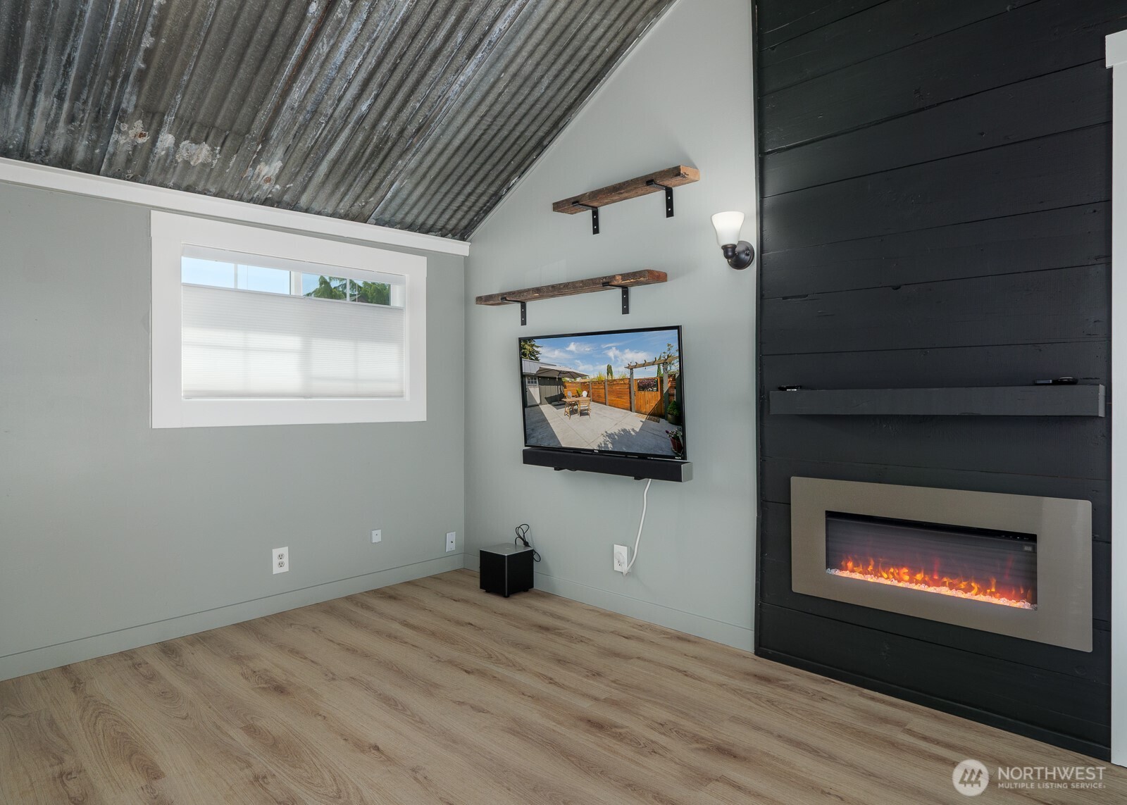 233 West Washington Street Sequim, WA 98382 - Photo 5 of 40 a view of an empty room with a fireplace and tv