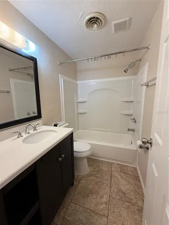 a bathroom with a double vanity sink toilet mirror and shower