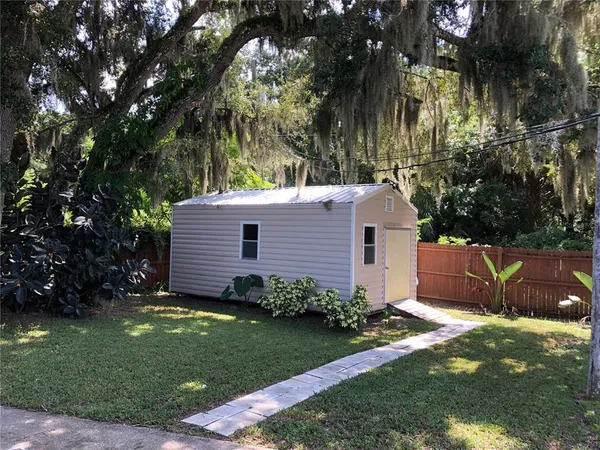 a view of backyard with garden and trees