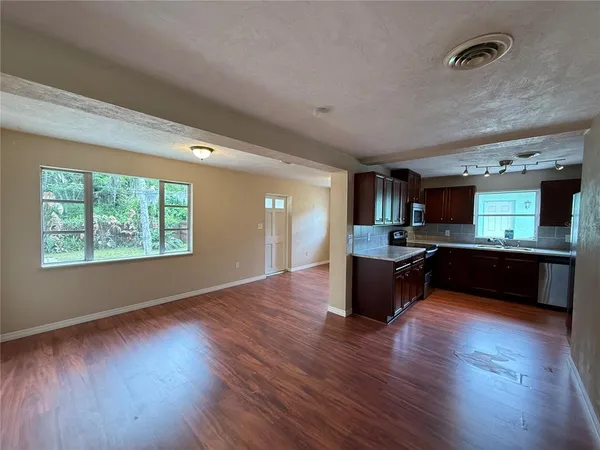 a large kitchen with lots of counter top space and stainless steel appliances