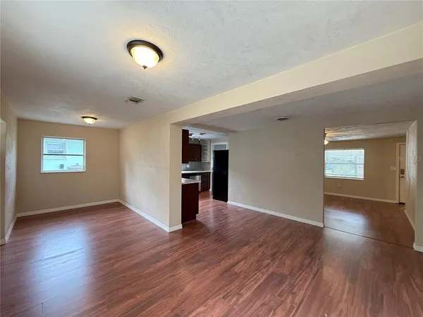 an empty room with wooden floor and closet