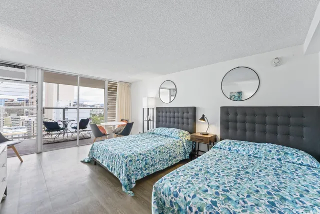 a bedroom with two beds and painting on the wall