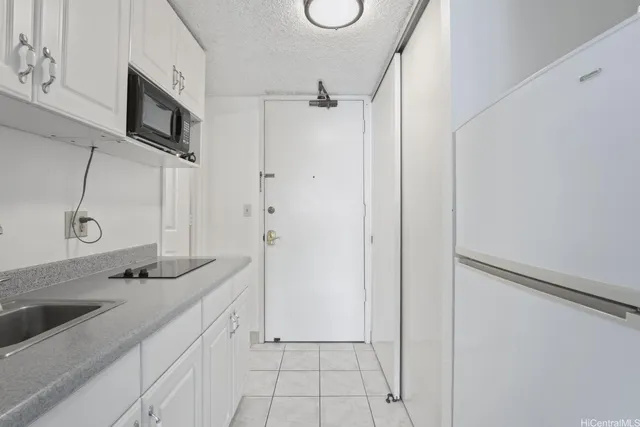 a bathroom with a granite countertop sink a mirror and shower