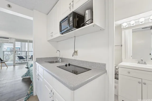 a kitchen with stainless steel appliances granite countertop a sink and a microwave