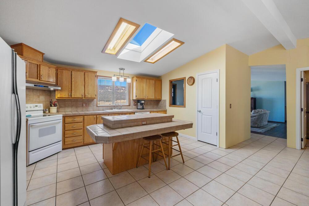 17550 South Poe Valley Road Klamath Falls, OR 97603 - Photo 13 of 59 a kitchen with stainless steel appliances granite countertop a sink and a refrigerator