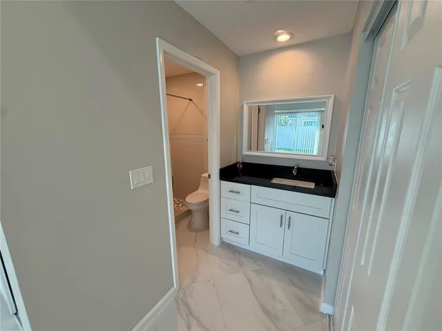 a view of a swimming pool with a patio and a garden