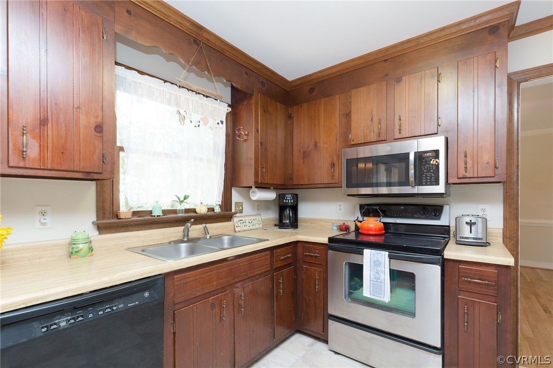 13904 2 Notch Road Midlothian, VA 23112 - Photo 23 of 48 a kitchen with stainless steel appliances a stove a sink and a microwave
