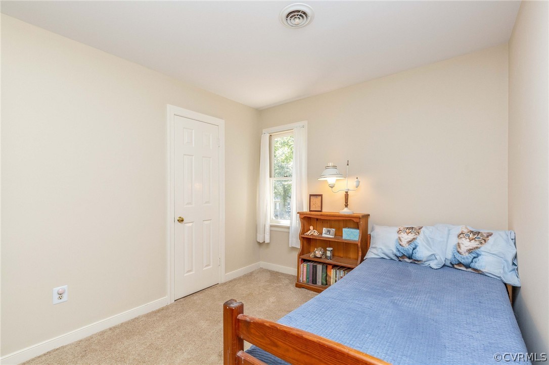 13904 2 Notch Road Midlothian, VA 23112 - Photo 36 of 48 a bedroom with a bed and a chandelier