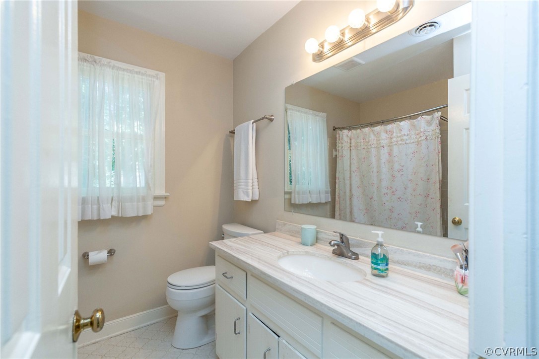 13904 2 Notch Road Midlothian, VA 23112 - Photo 37 of 48 a bathroom with a granite countertop sink a toilet and a mirror