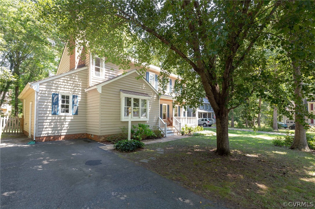 13904 2 Notch Road Midlothian, VA 23112 - Photo 5 of 48 a front view of a house with a garden and trees