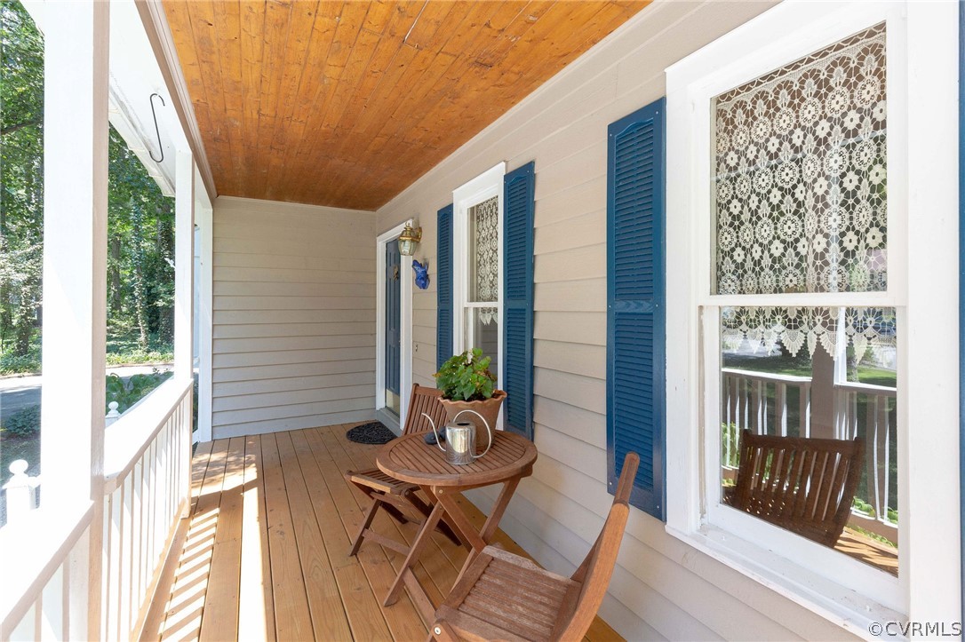 13904 2 Notch Road Midlothian, VA 23112 - Photo 7 of 48 a view of a porch with chairs and floor to ceiling window with wooden floor
