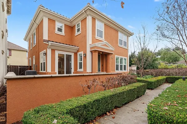 a front view of a house with garden