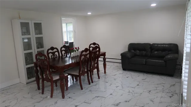 a view of a dining room with furniture and window