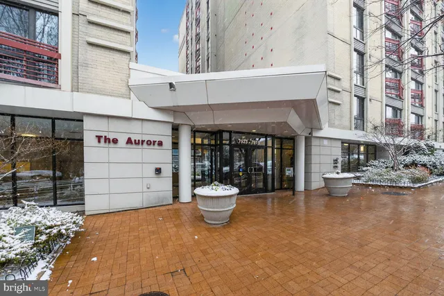 a front view of a building with outdoor seating