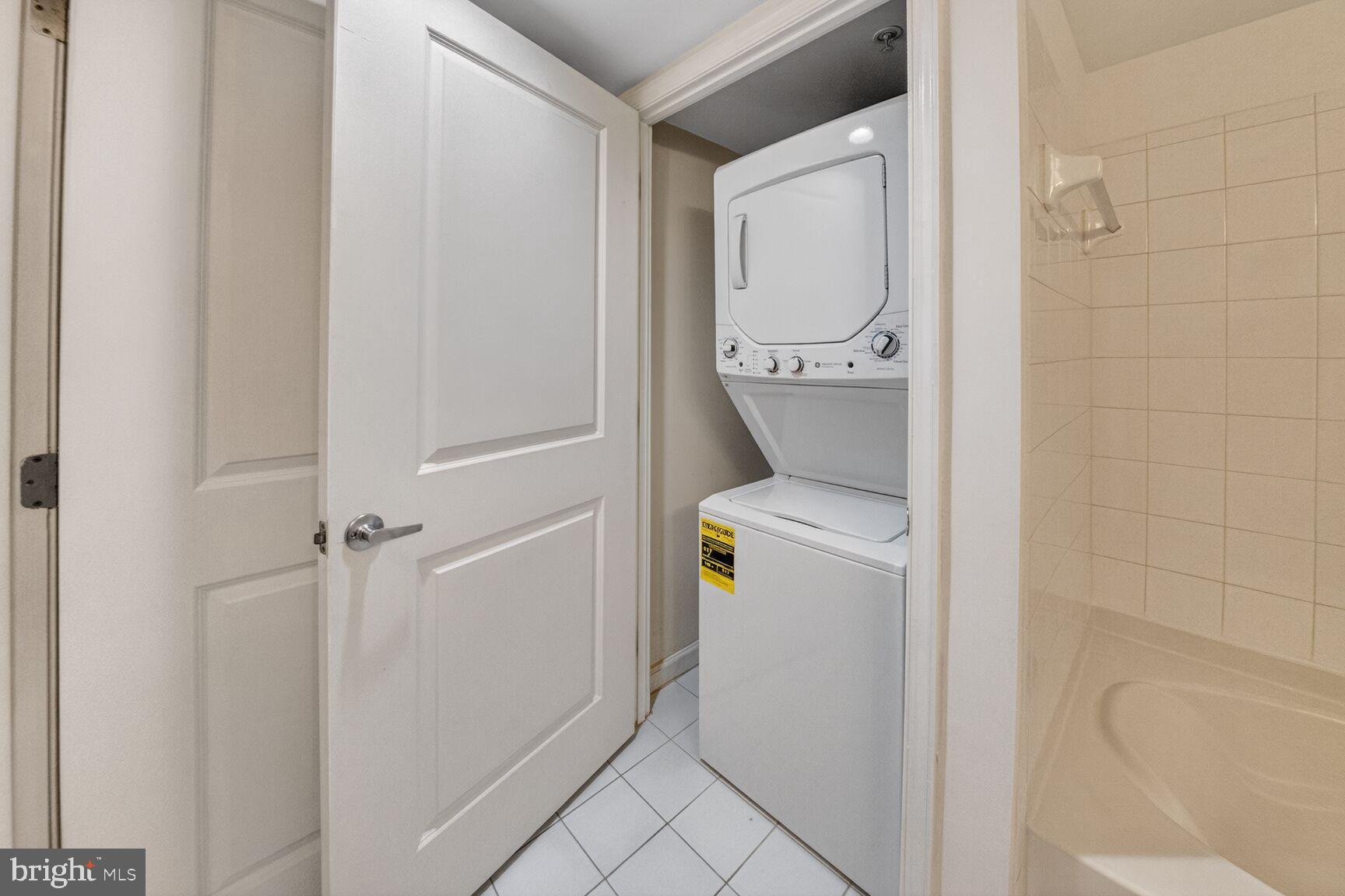 7923 Eastern Avenue Northwest, Unit 404 Silver Spring, MD 20910 - Photo 16 of 18 a bathroom with a washer and dryer