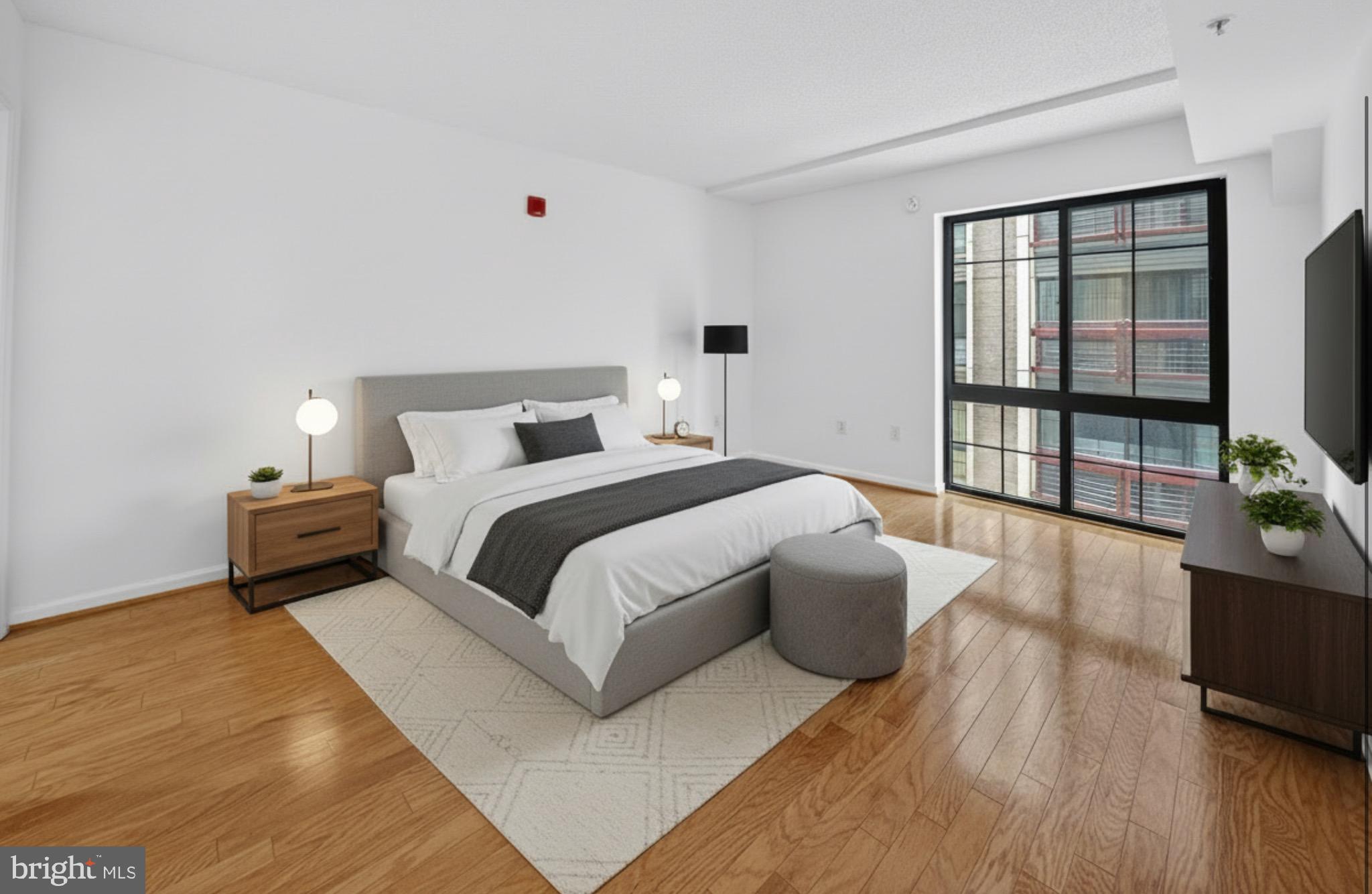 7923 Eastern Avenue Northwest, Unit 404 Silver Spring, MD 20910 - Photo 8 of 20 a bedroom with a large bed and windows