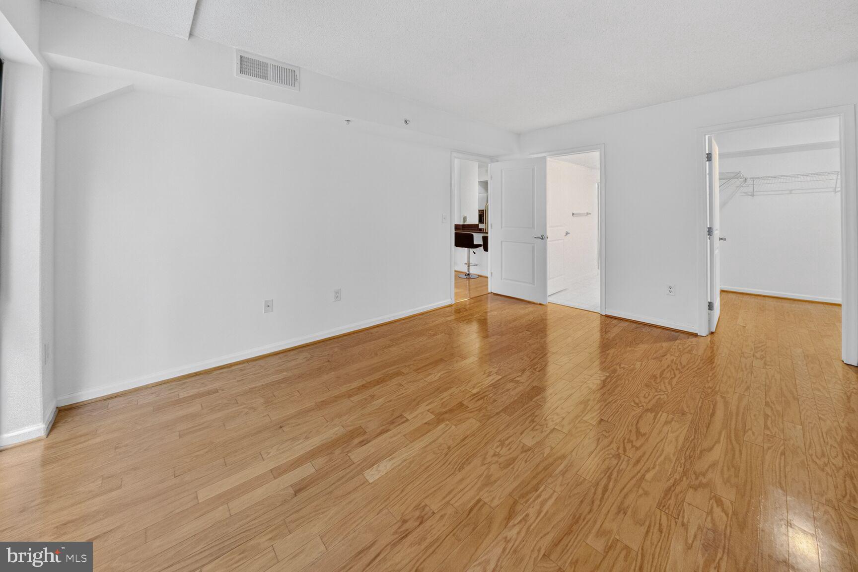 7923 Eastern Avenue Northwest, Unit 404 Silver Spring, MD 20910 - Photo 9 of 18 a view of empty room with wooden floor