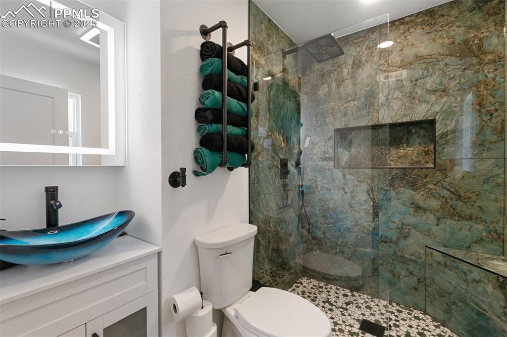 1921 Van Diest Road Colorado Springs, CO 80915 - Photo 18 of 45 Bathroom featuring a marble finish shower and vanity