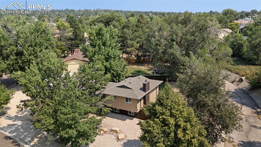 1921 Van Diest Road Colorado Springs, CO 80915 - Photo 26 of 45 Aerial view of property and surrounding area with a forest