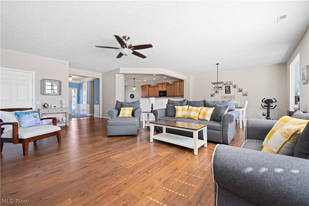 9188 Prairie Moon North Ridgeville, OH 44039 - Photo 10 of 40 Living room with ceiling fan, a textured ceiling, and wood-type flooring