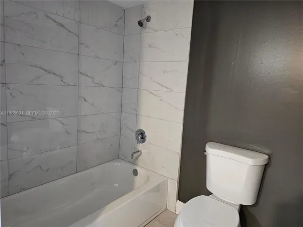 a bathroom with a bathtub and a toilet