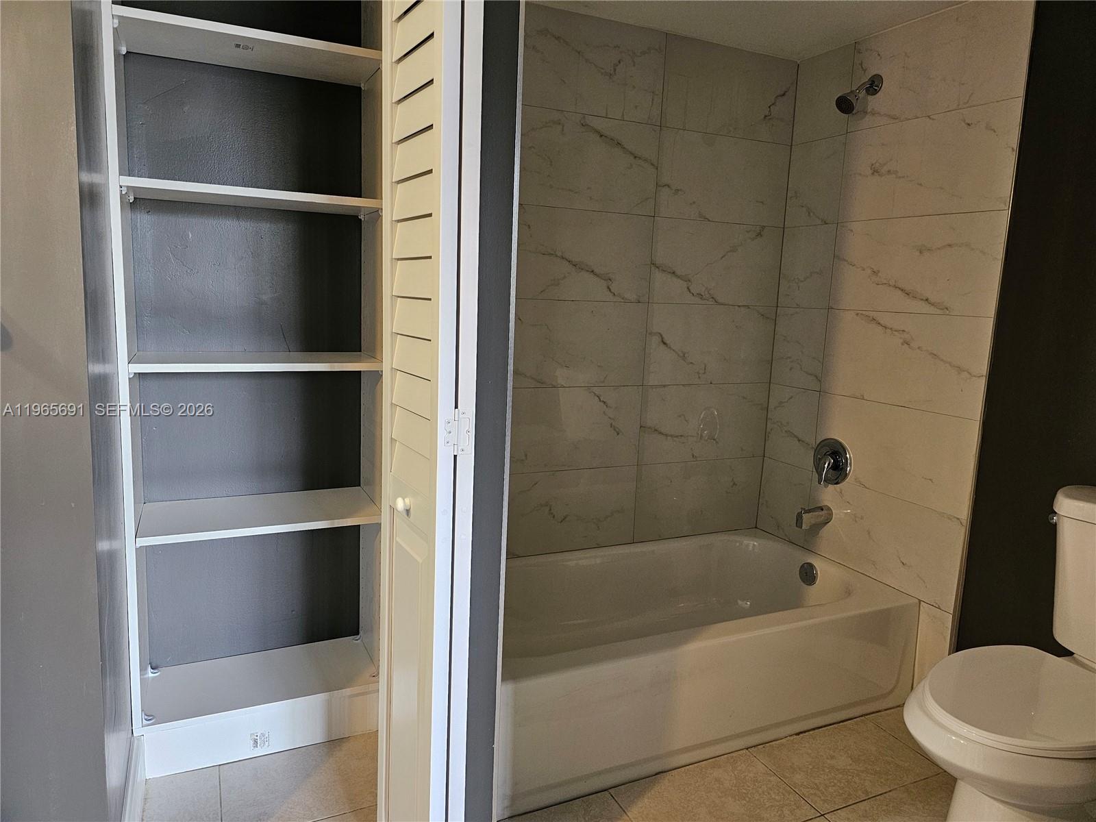 2051 Renaissance Boulevard, Unit 104 Miramar, FL 33025 - Photo 14 of 39 a bathroom with a bathtub and a toilet