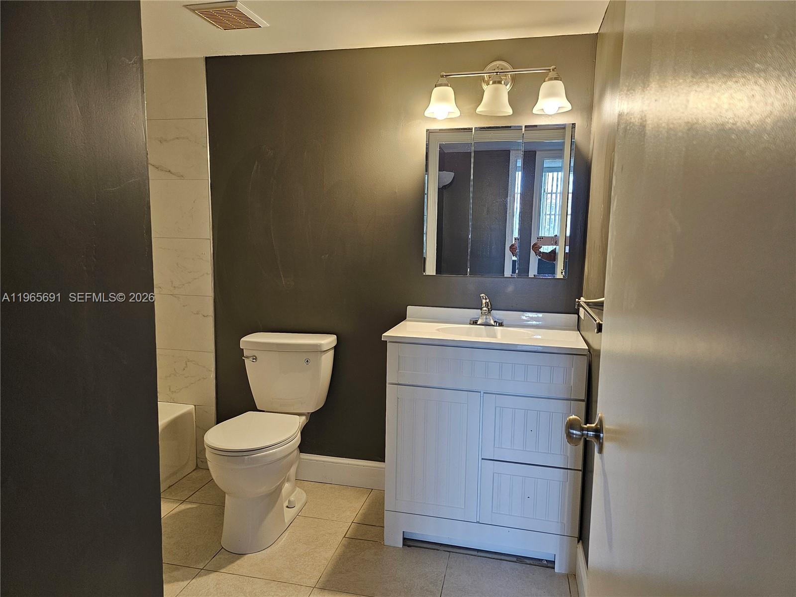 2051 Renaissance Boulevard, Unit 104 Miramar, FL 33025 - Photo 22 of 39 a bathroom with a sink and a mirror
