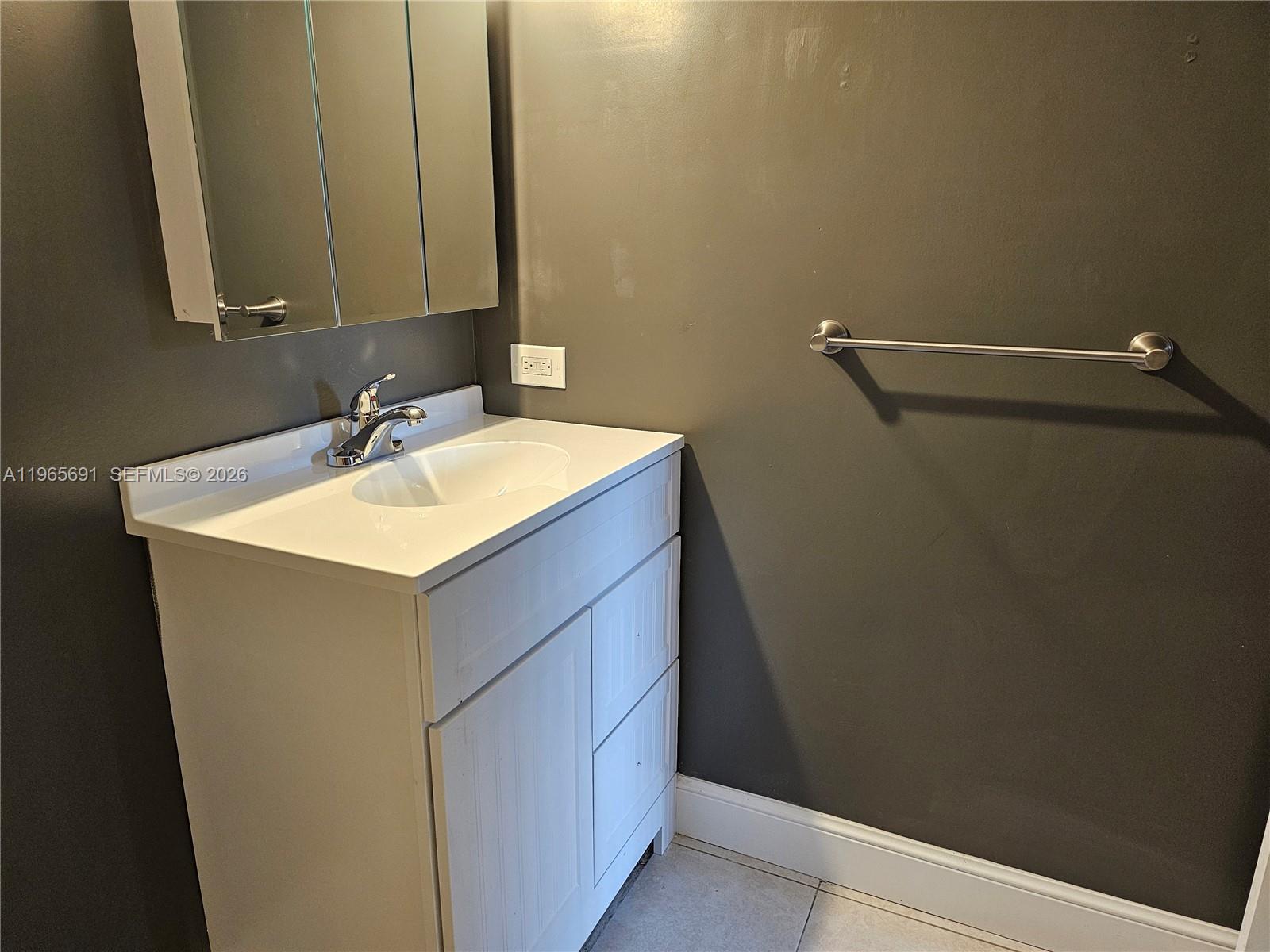 2051 Renaissance Boulevard, Unit 104 Miramar, FL 33025 - Photo 24 of 39 a bathroom with a sink vanity and a mirror