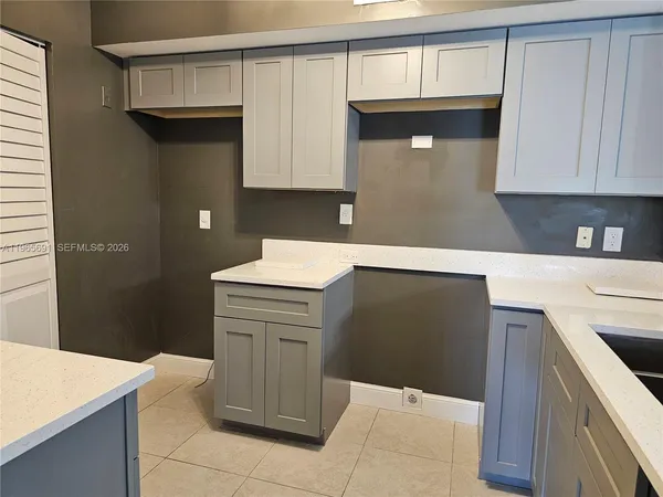 a kitchen with a sink and a mirror