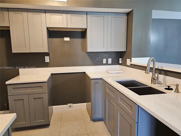 a kitchen with a sink cabinets and window