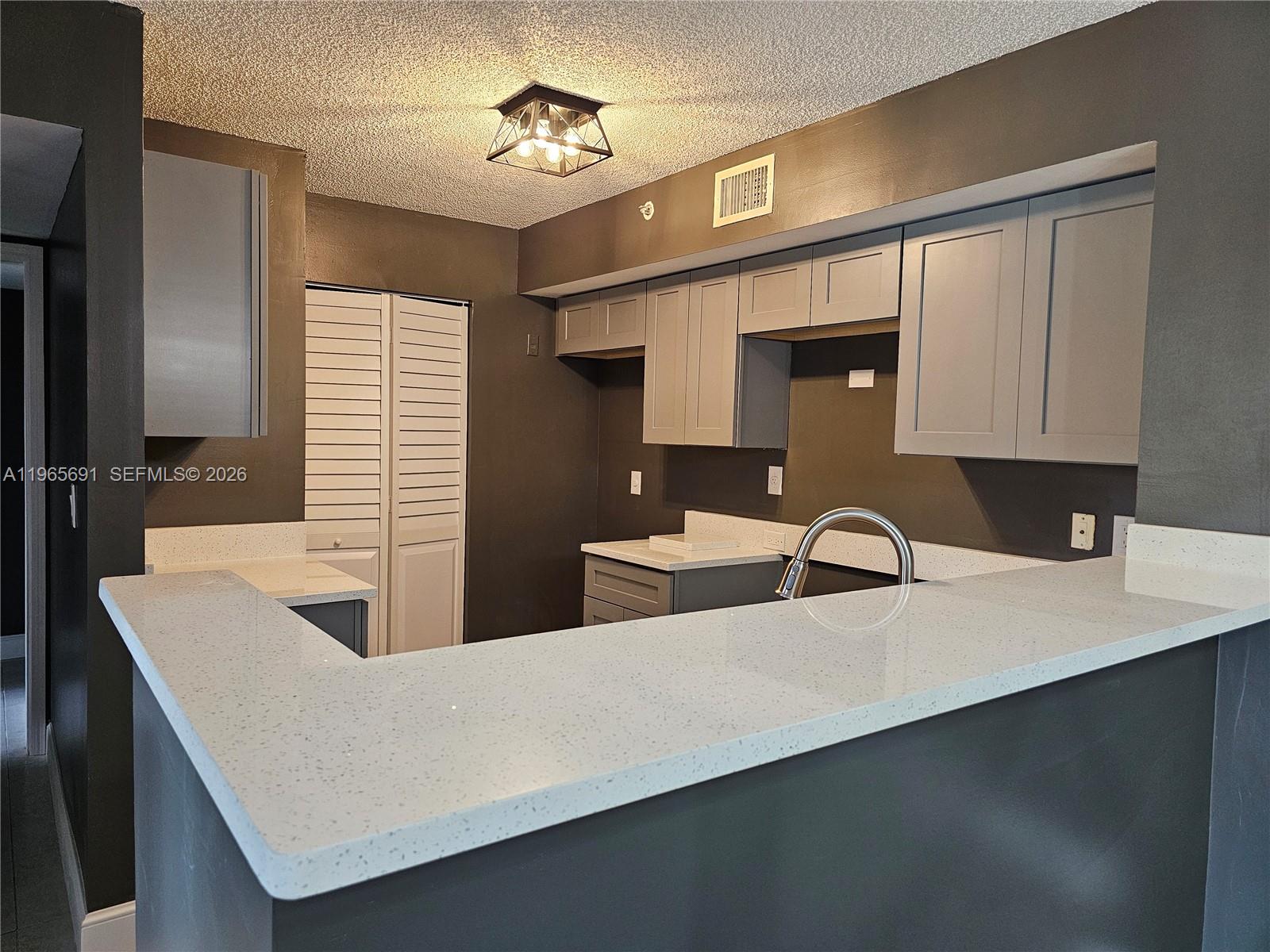 2051 Renaissance Boulevard, Unit 104 Miramar, FL 33025 - Photo 28 of 39 a kitchen with a sink cabinets and window