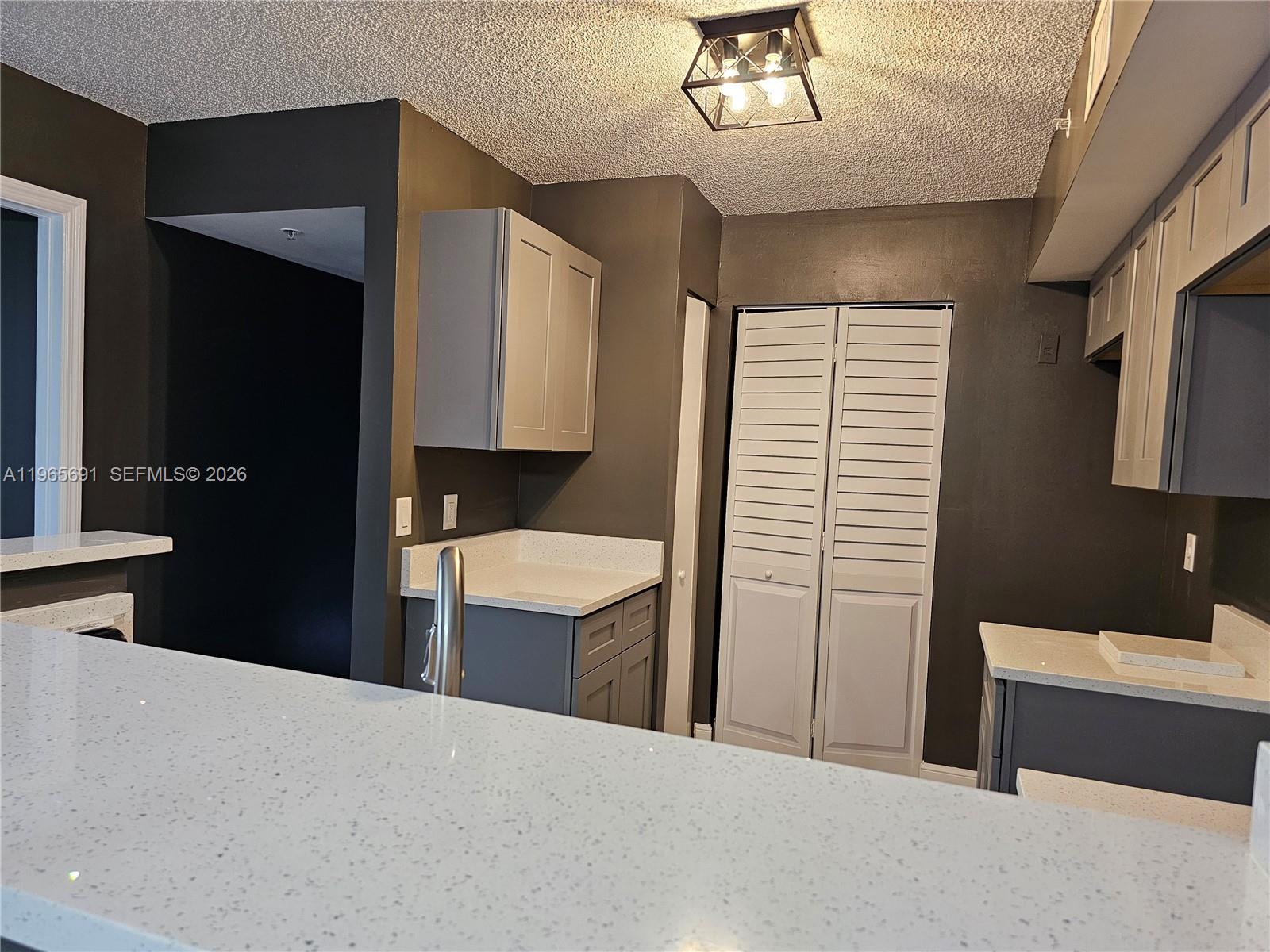 2051 Renaissance Boulevard, Unit 104 Miramar, FL 33025 - Photo 29 of 39 a bedroom with a bed and a sink